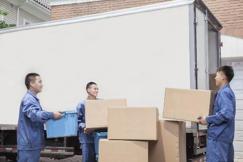 Packed boxes and furniture prepared for transport by removals van