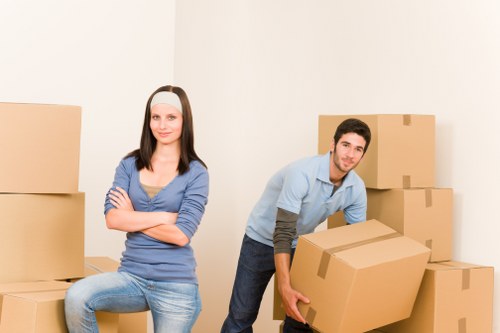 Professional moving team handling household items in Palmers Green
