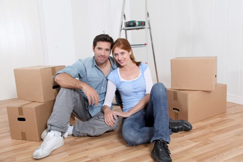 Residents and movers separating cardboard, metal, and household waste for recycling
