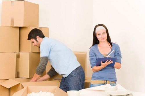 Prepared boxes and furniture ready for moving truck collection in Palmers Green