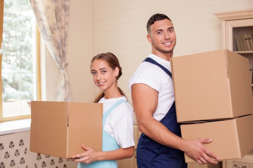 Removal crew carrying office equipment through a commercial building