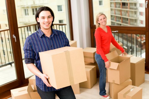 Office desks and boxes arranged for setup at a new workplace